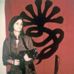 Patty Hearst in front of SLA banner